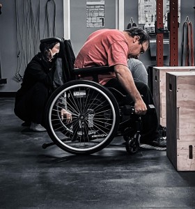 Athlete using wheelchair and lifting weights